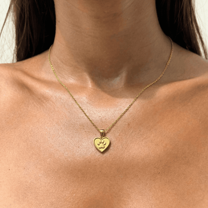 Close up gold paw and heart dog charity necklace that helps fund 30 shelter dog meals