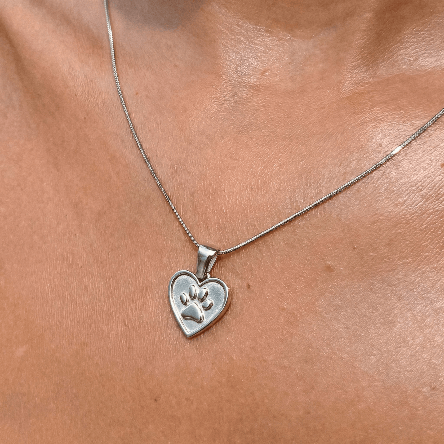 Silver paw and heart dog charity necklace that helps fund 30 shelter dog meals