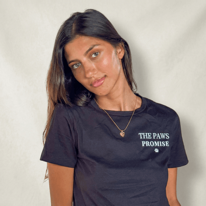 Woman wearing The Paws Promise dog charity necklace that helps fund 30 shelter dog meals